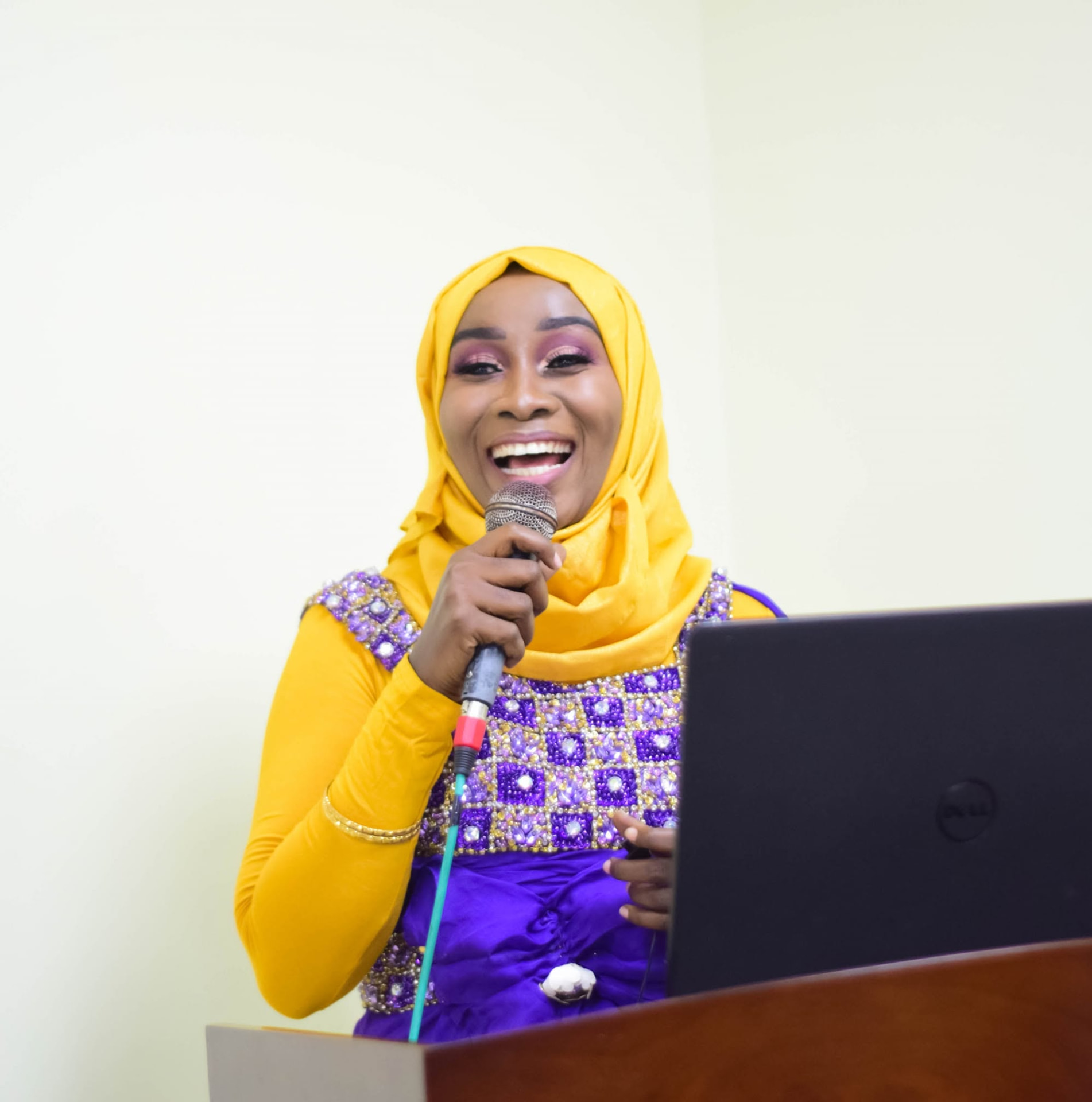 Founder of Ustaarabu wa Mwanamke speaking at a podium in Zanzibar